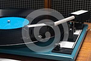 Equipment for listening to vinyl records on a brown table, side view