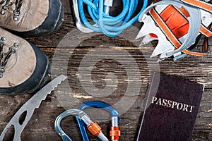 Equipment for mountaineering and hiking on wooden background.