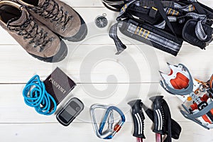 Equipment for mountaineering and hiking on wooden background.