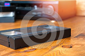 Equipment for playing VHS tapes on a wooden table photo