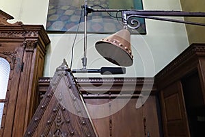 Equipment for prayer and ceremonial chants in Christian Orthodox Church. Microphone on stand, antique bronze earpiece