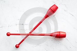 Equipment for rhythmic gymnastics. Clubs on white background top view copy space