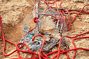 Equipment for rock climbing and ropejumping: carabiners and ropes on the rock close-up.