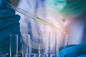 Equipment and science experiments oil pouring scientist with test tube green making research in laboratory.