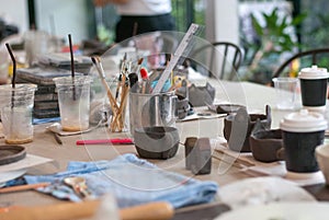 Equipments and handcraft tools on working table ready to make ceramic work, art hobby