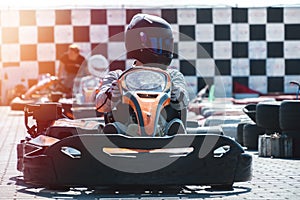 Equipped drivers are sitting in a racing car. Ready for battle, championship. Go karts racing, sreet extreme sport. fun