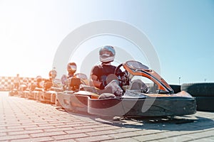 Equipped drivers are sitting in a racing car. Ready for battle, championship. Go karts racing, sreet karting, rent. extreme sport