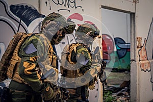 Equipped special forces soldiers in action, an operation in a dilapidated building