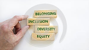 Equity, diversity, inclusion and belonging symbol. Wooden blocks with words `equity, diversity, inclusion, belonging` on beautif