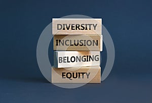 Equity, diversity, inclusion and belonging symbol. Wooden blocks with words `equity, diversity, inclusion, belonging` on beautif