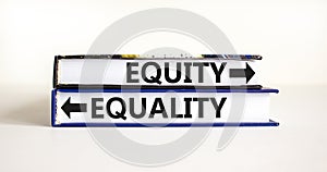 Equity or equality symbol. Concept word Equity or Equality on beautiful books. Beautiful white table white background. Business