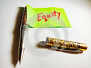 equity share market related text displayed on green colour paper slip with pen concept