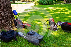 Equopment of a news crew in a park left on grass while taking interview