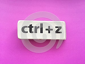eraser with the inscription & x22;ctrl + z& x22; on a violet background photo