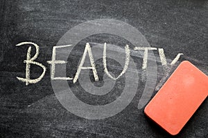 Erasing beauty, hand written word on blackboard being erased