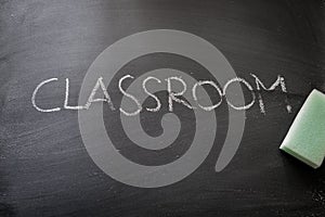 Erasing classroom, hand written word on blackboard being erased concept