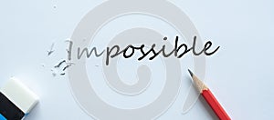 Erasing IMPOSSIBLE text change to POSSIBLE. challenge, positive thinking and success concept