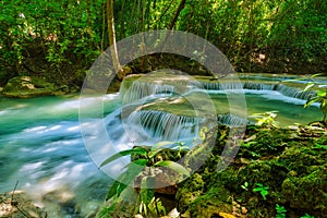 Erawan Waterfall, Kanchanaburi  Thailand, natural waterfalls, beautiful green forests, with fish in the water as a