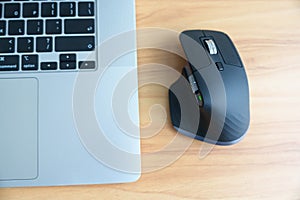Ergonomic vertical mouse with laptop computer on adjustable desk at workplace, prevention wrist pain. De Quervain s tenosynovitis