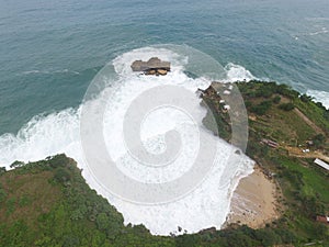 Erial top view of sea with waves hitting rocks