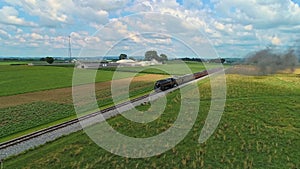 Erial View of Amish Farm lands and a Steam Passenger Train Approaching in the Distance