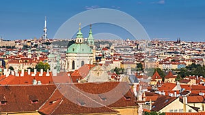 erial view of old Red Tiles roofs in the city Prague, Czech Republic, Europe. Beautiful day with blue sky with clouds in the town. photo