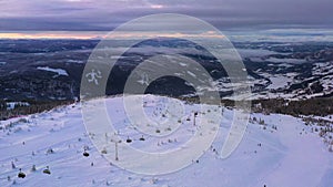 Erial view of ski resort Hafjell in Norway with skiers going down the snowy slopes in winter