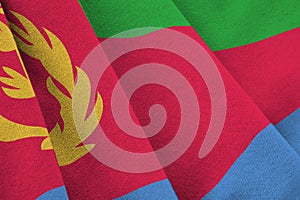 Eritrea flag with big folds waving close up under the studio light indoors. The official symbols and colors in banner