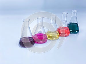 The Erlenmeyer or Conical flask on bench laboratory, with colorful solvent solution from titration experiment, acidity, alkalinity