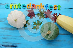 Erntedankfest harvest festival in Germany. Pumpkin, squash, wooden blue background