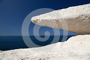 Eroded chalk rock white stone blue sky and sea