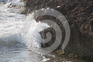 Eroded limestone rock and wave