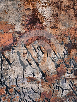 Eroded metal texture with black paint smudges, abstract grunge background