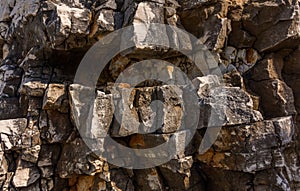 Eroded natural stone coastal wall in Kassiopi, Corfu, Greece