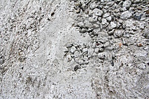 Eroded old grey concrete at a wall for dirty texture, background