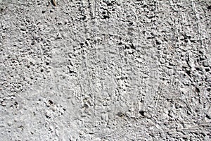 Eroded old grey concrete at a wall for dirty texture, background