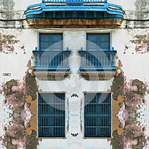 Eroded Old Havana facade with blue windows