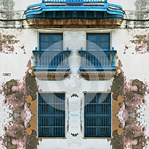 Eroded Old Havana facade with blue windows photo