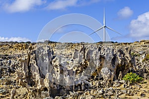 Eroded rock formations and wind turbines - renewable energy and earth conservation concept.