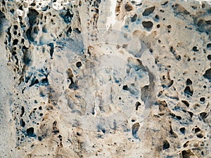 Eroded rocks with holes beside the sea