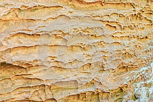 Eroded sandstone rock formation with textured layers in natural setting