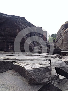 Eroded steps & cave openings along passage formed by natural canyon running east to west, Udayagiri Caves, Vidisha, India