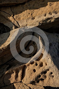 Eroded stone wall background with holes