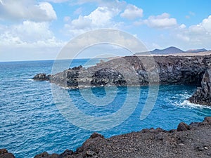 Eroded volcanic sea caves and cliffs at Los Hervideros in Lanza