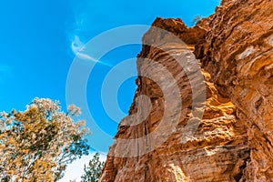 Eroding orange sandstone cliffs.