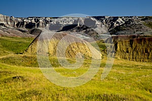 Eroding peaks and prairie grass of the Badlands National Park So