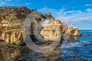 Eroding rocks at ocean coastline. photo