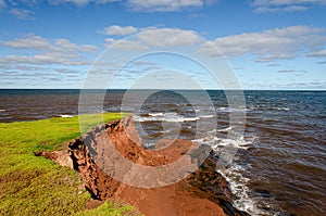 Erosion red rocks falling into the ocean on pei island