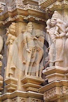 Erotic statues on the walls outside the temple of khajuraho