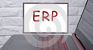 ERP, enterprise resource planning an inscription on a magnetic board hanging on a brick wall